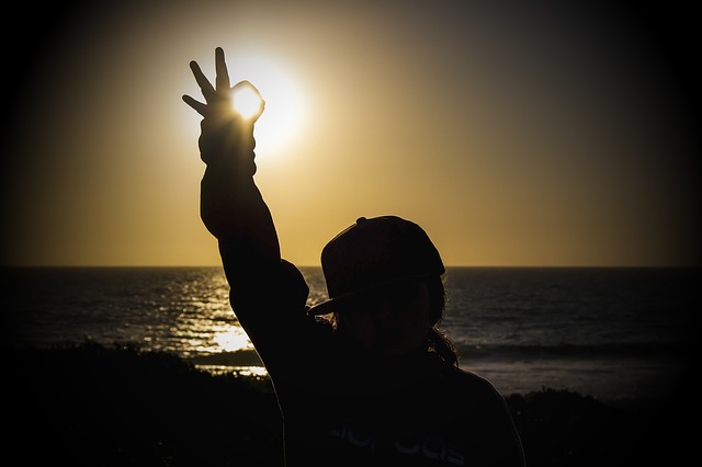 A person standing in front of a sunset