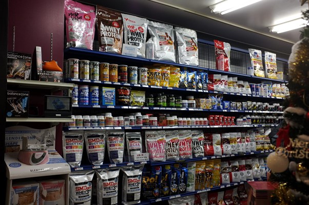 Supermarkets shelves showing whey protein products.